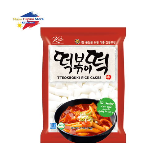 Packaged teokbokki rice cakes with a bowl of rice cake on a white background, featuring the brand 'Korean'.